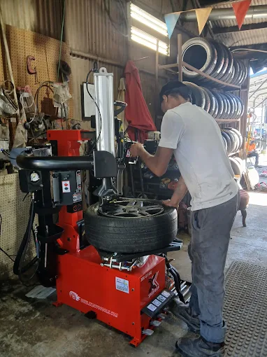 Technician mounting a tire on the balancing machine at Jesse's Tires
